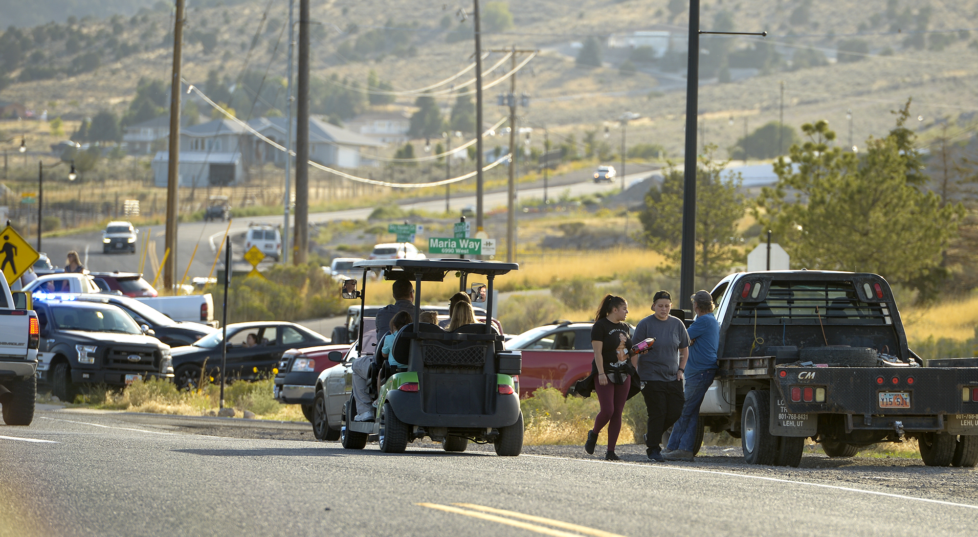 Leah Hogsten | The Salt Lake Tribune Homeowners who were not allowed to return to their homes and onlookers waited near Herriman Cove pond to watch as a firefighting helicopter refilled. A 50-acre wildfire in Rose Canyon was threatened about a half-dozen homes Wednesday, Sept. 12, 2018. A spokesman for Unified Fire said the blaze has already burned a few structures, including outhouses and sheds. Firefighters have evacuated around 20 to 30 homes in two neighborhoods near 15555 S. Rose Canyon Road in Herriman. 