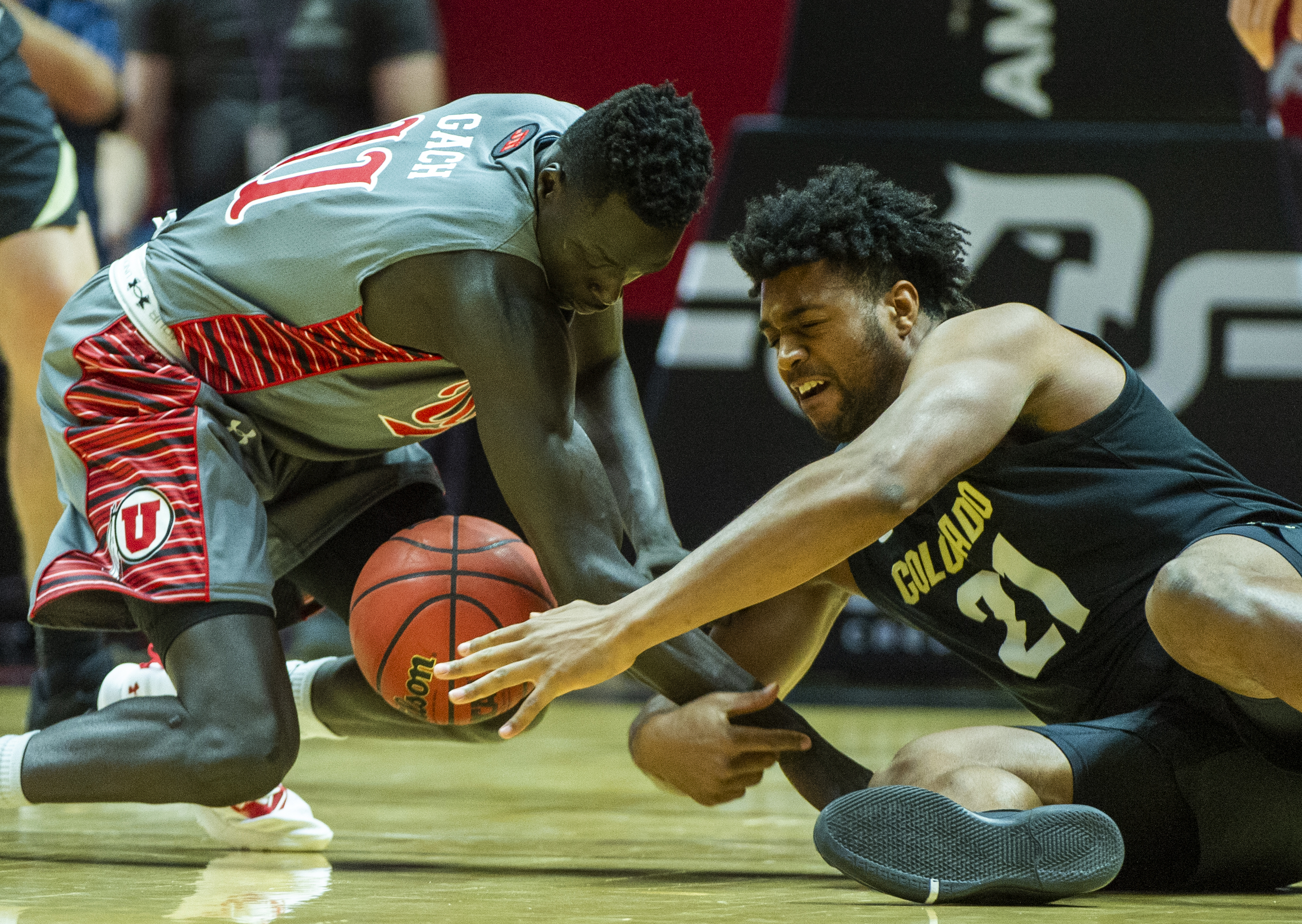 (Rick Egan | The Salt Lake Tribune) Utah Utes forward Both Gach (11) goes for a loose ball along with Colorado Buffaloes forward Evan Battey (21), in PAC-12 basketball action between the Utah Utes and the Colorado Buffaloes at the Jon M. Huntsman Center, Sunday, Jan. 20, 2019. 