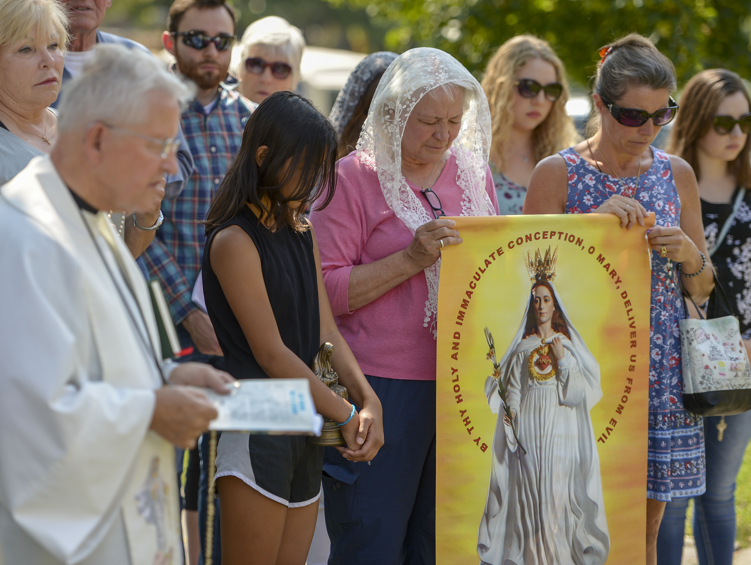 Leah Hogsten | The Salt Lake Tribune Catholic priest, Rev. Jan Bednarz of St. Martin de Porres Parish in Taylorsville, leads the "blessed sacrament" and exorcism at the Planned Parenthood offices on the Feast of the Assumption. Bednarz was joined by the group, "40 Days for Life Utah," to protest Planned Parenthood. 