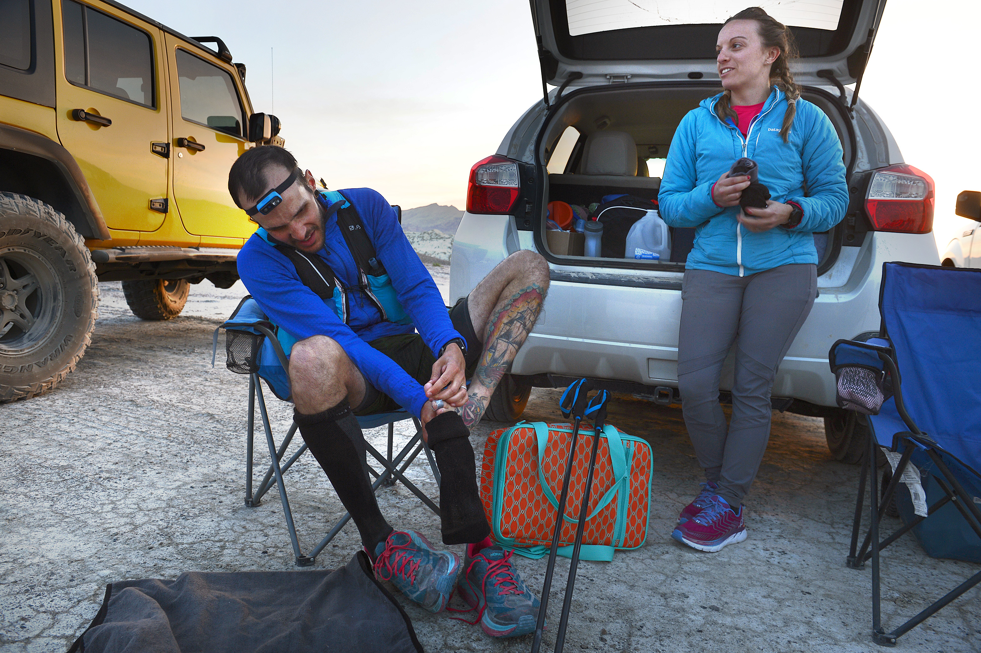 (Scott Sommerdorf | The Salt Lake Tribune) Alex Doolan changes his socks and tends to his feet at the last checkpoint at the Salt Flats 100 Endurance Run, Saturday, May 5, 2018. 