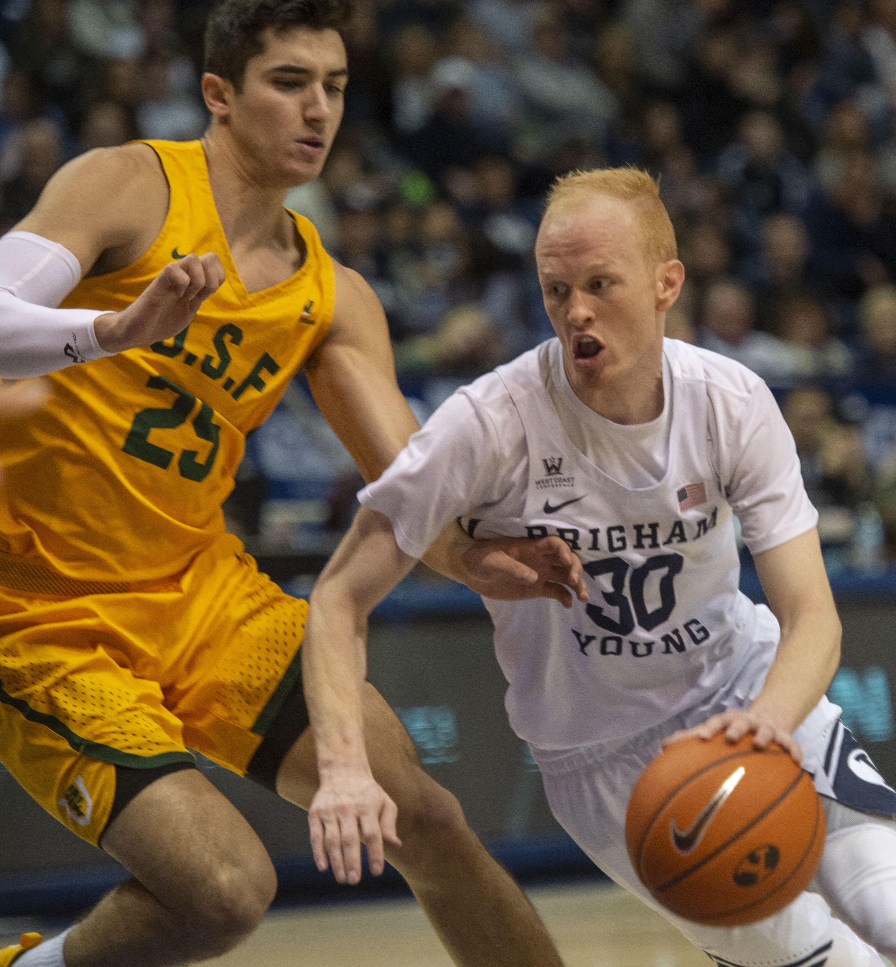 (Rick Egan | The Salt Lake Tribune) Brigham Young Cougars guard TJ Haws (30) takes the ball up the middle, as San Francisco Dons guard Jordan Ratinho (25), in WCC basketball action at the Marriott Center, Thursday, February 21, 2018. 