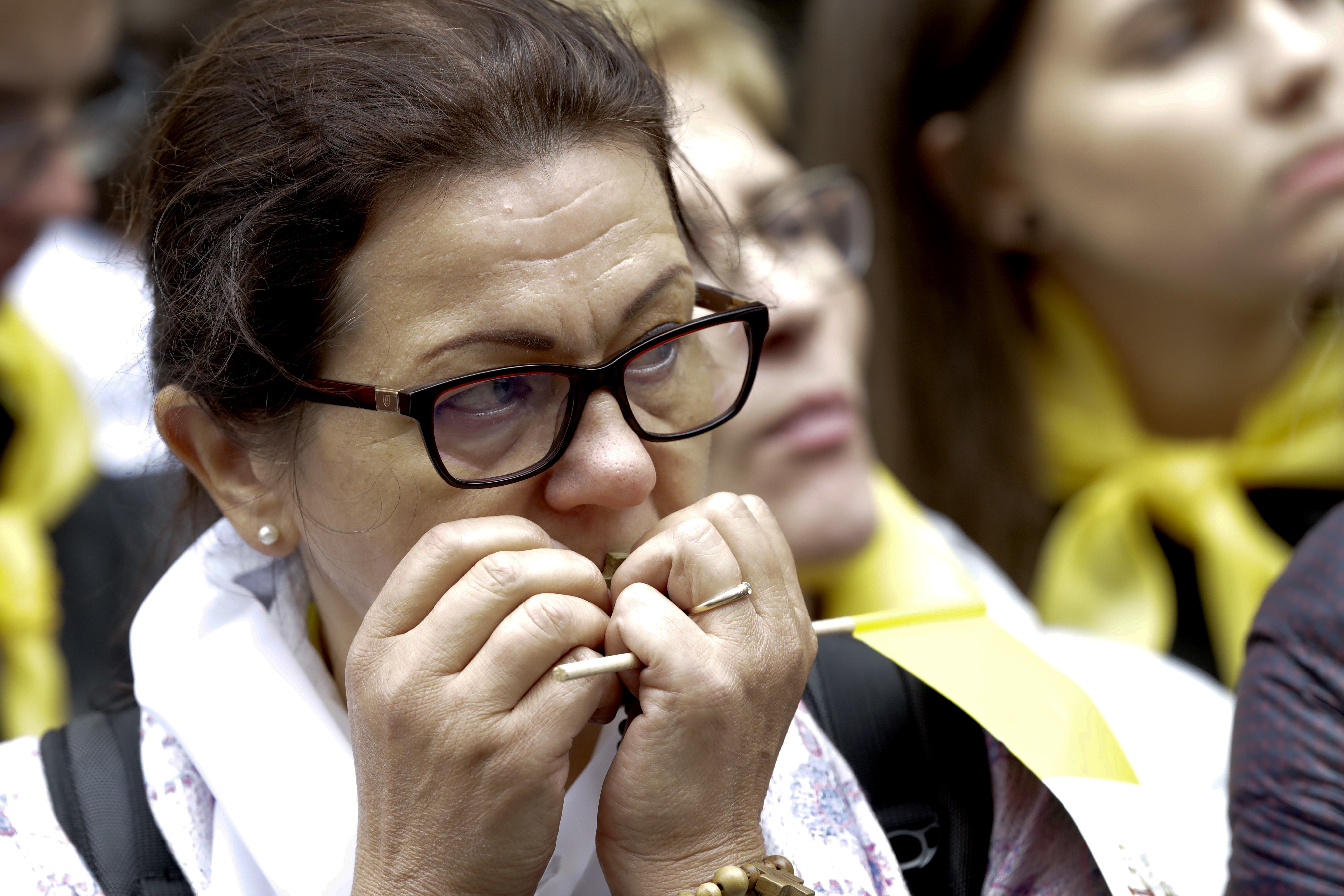(Andrew Medichini | AP Photo) A woman prays with a rosary as she waits with others for the arrival of Pope Francis' visit at the Mater Misericodie Shrine, in Vilnius, Lithuania, Saturday, Sept. 22, 2018. Pope Francis urged Lithuanians to use their decades of suffering under Soviet and Nazi occupations to become models of tolerance in an intolerant world as he began a three-nation tour of the Baltics on Saturday amid renewed alarm over their giant neighbor Russia.