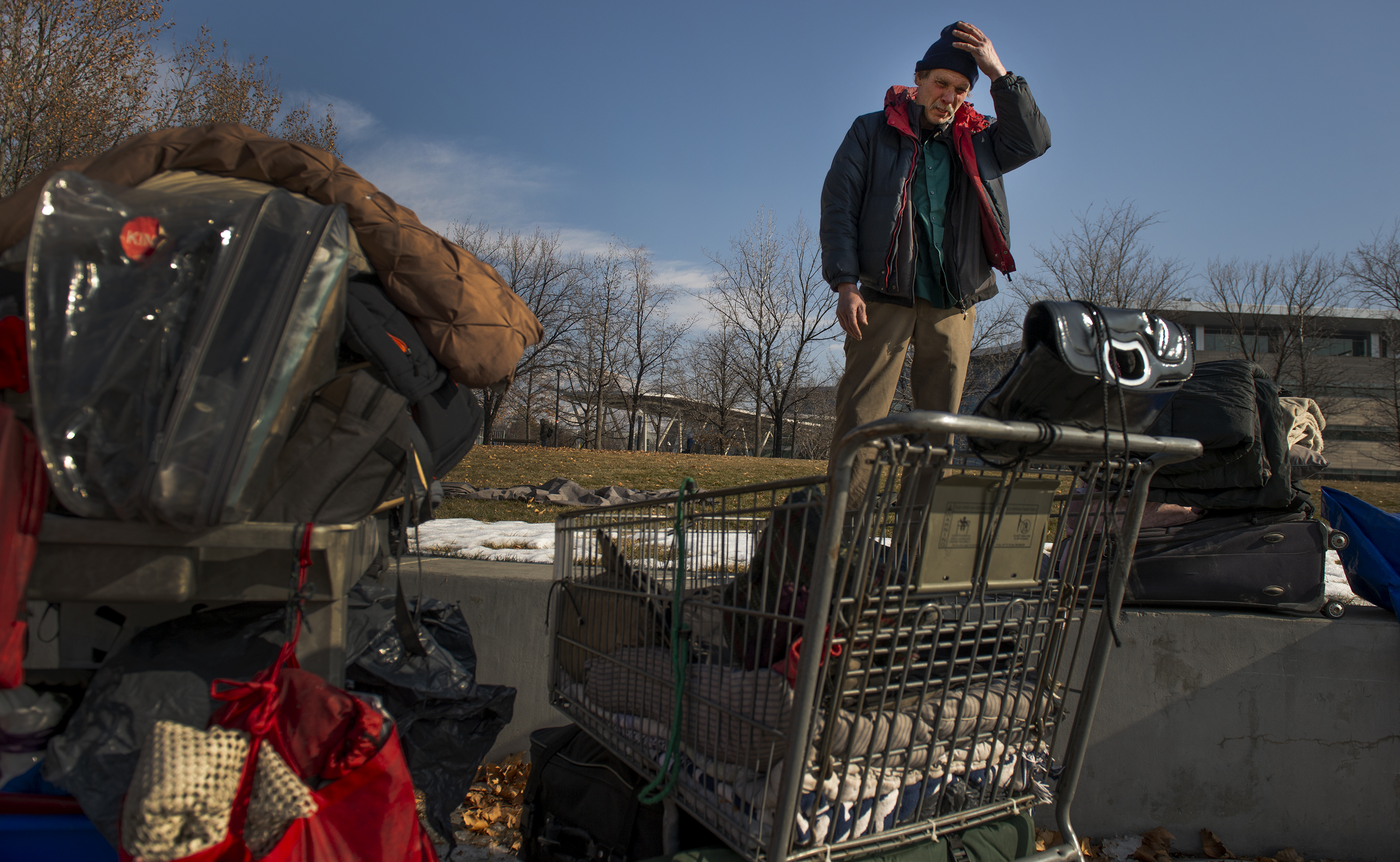 (Leah Hogsten | The Salt Lake Tribune) Ron Barrett is overwhelmed as he looks over the four shopping carts that contain his and his wife's belongings. Hours before, police officers told the homeless couple to move their tent and belongings two times during the night or risk getting another 'no camping' ticket. Ron's goal was to re-pack the tent they've been living in Salt Lake City, get organized and downsize for easier mobility, but sleep deprivation and anxiety from the night's events wore him down. "They [police officers] call our tent the "Hobo Palace," Barrett said.
