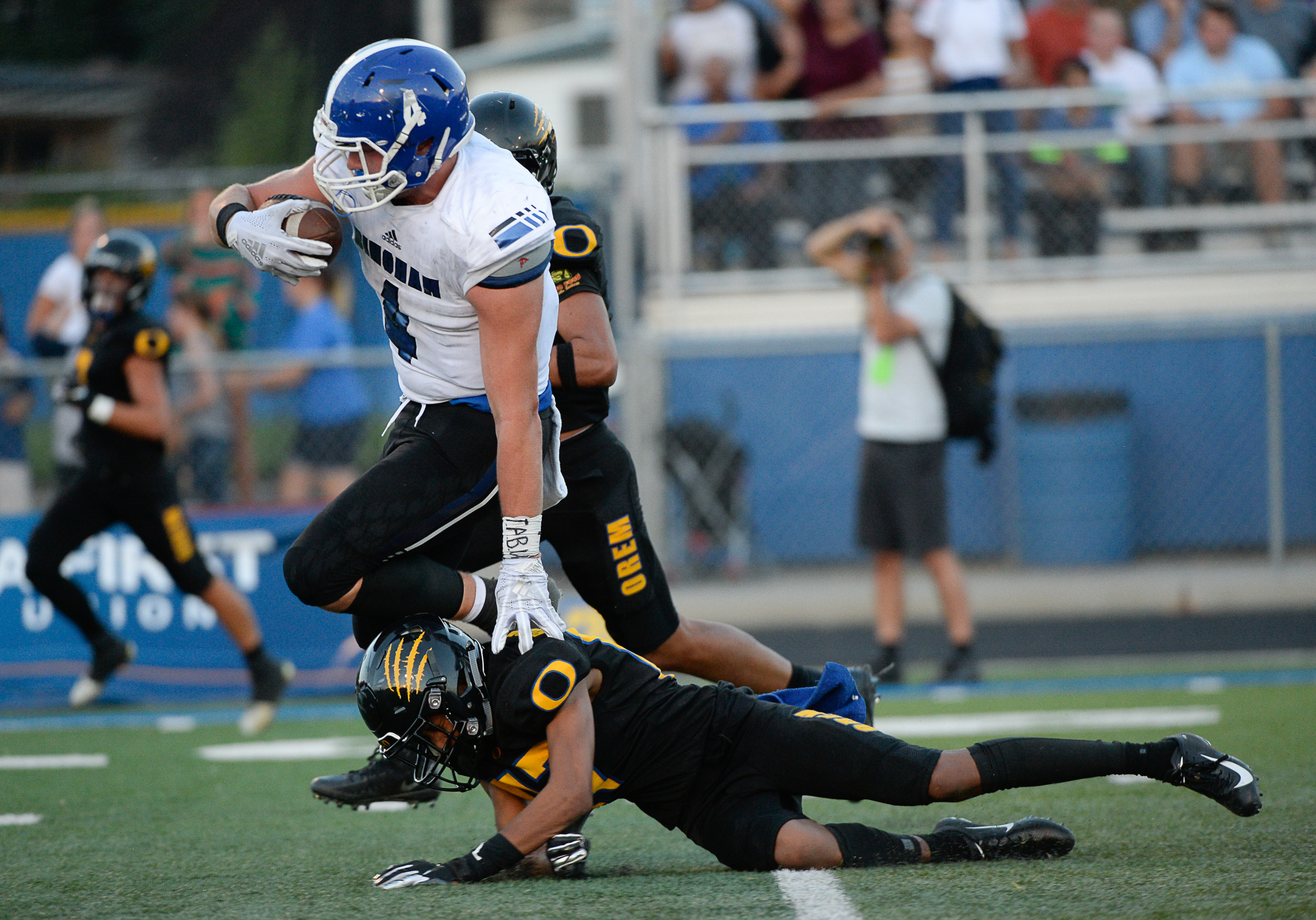 (Francisco Kjolseth | The Salt Lake Tribune) Bingham's Briasen Harward runs over Orem's Jakob Robinson as he nears the end zone, Thursday, Aug. 16, 2018 in Orem.