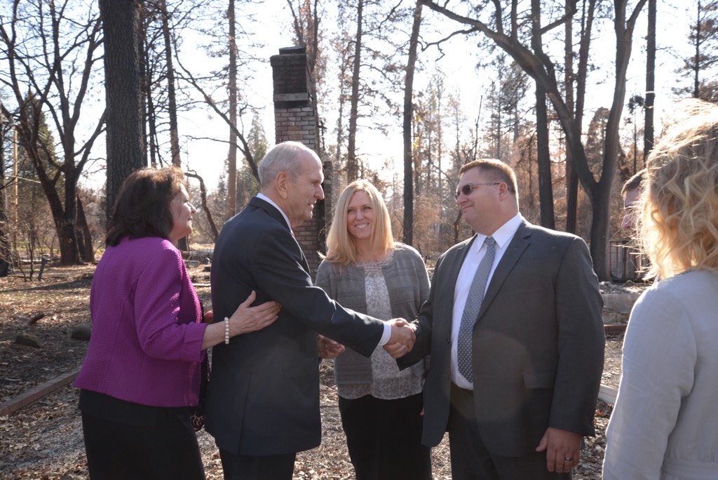 (Photo courtesy of The Church of Jesus Christ of Latter-day Saints) After his meeting in Chico, Calif., Jan. 13, 2019, President Russell M. Nelson met with Rob and Gretchen Harrison and their three children in front of what used to be their home.