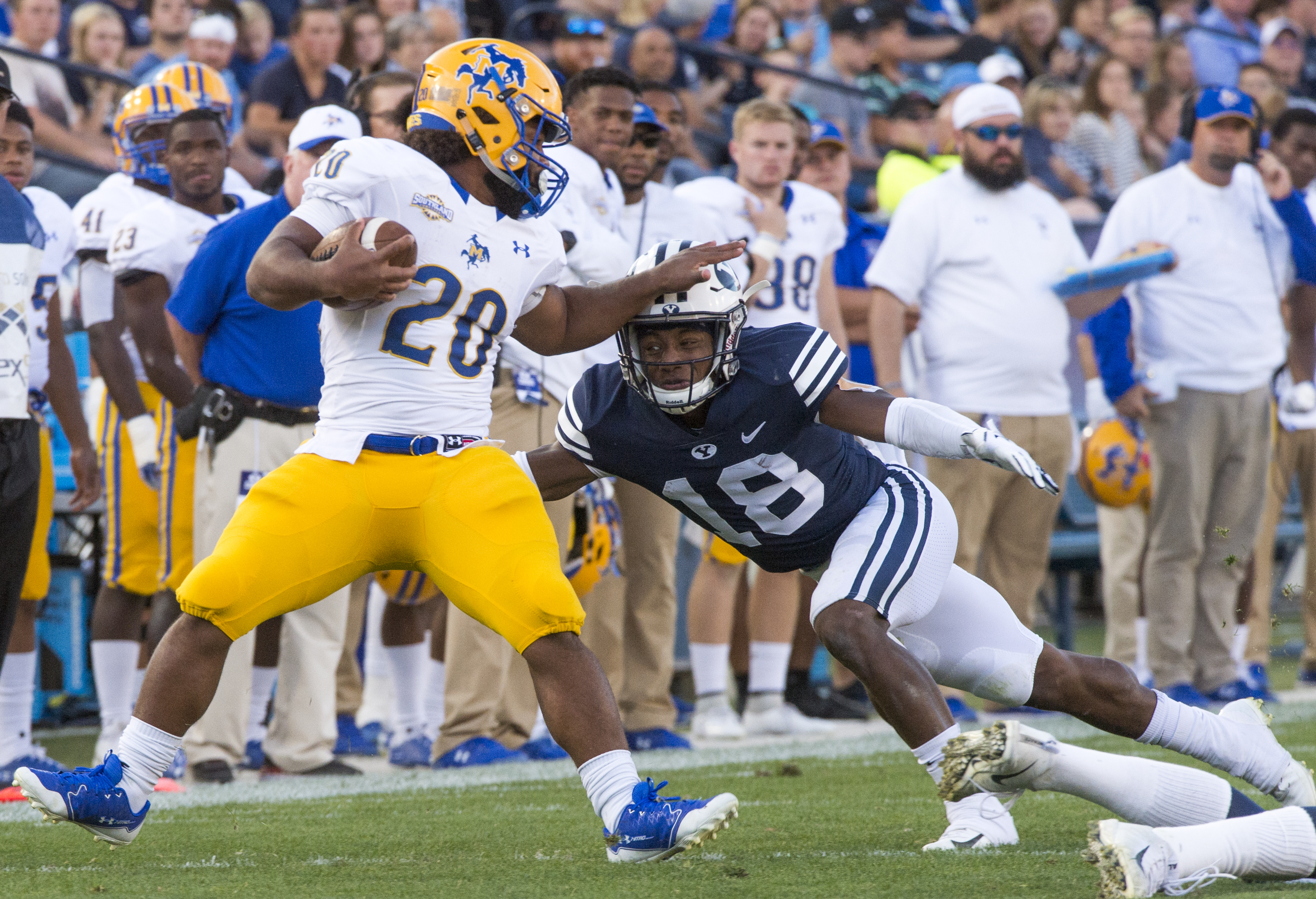 (Rick Egan | The Salt Lake Tribune) Brigham Young Cougars defensive back Michael Shelton (18) brings down McNeese State Cowboys running back Justin Pratt (20), in football action Brigham Young Cougars vs McNeese State Cowboys at Lavell Edwards Stadium, Saturday, Sept. 22, 2018. 