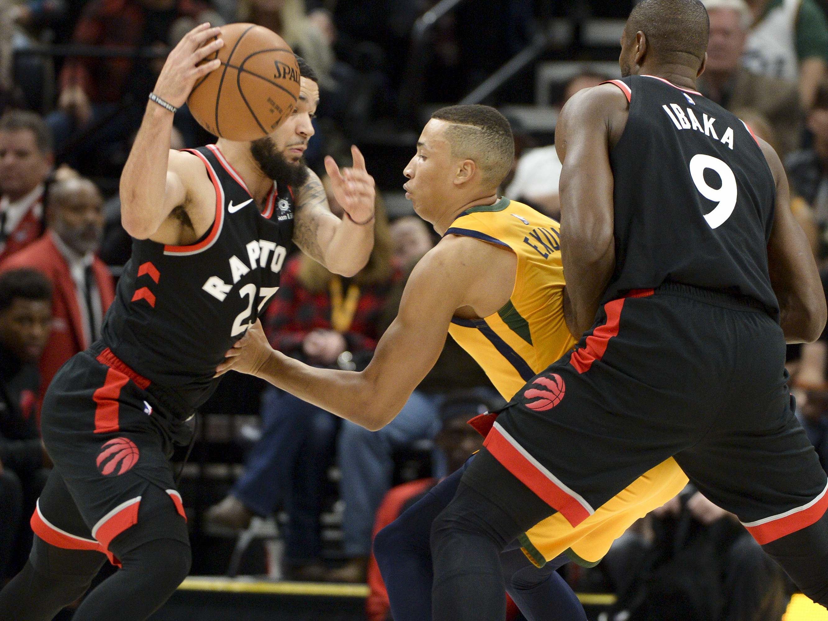 Leah Hogsten | The Salt Lake Tribune Utah Jazz guard Dante Exum (11) is blocked by Toronto Raptors forward Serge Ibaka (9) trying to stay with Toronto Raptors forward Chris Boucher (25) as the Utah Jazz host the Toronto Raptors, Monday, Nov. 5, 2018 at Vivant Smart Home Arena.