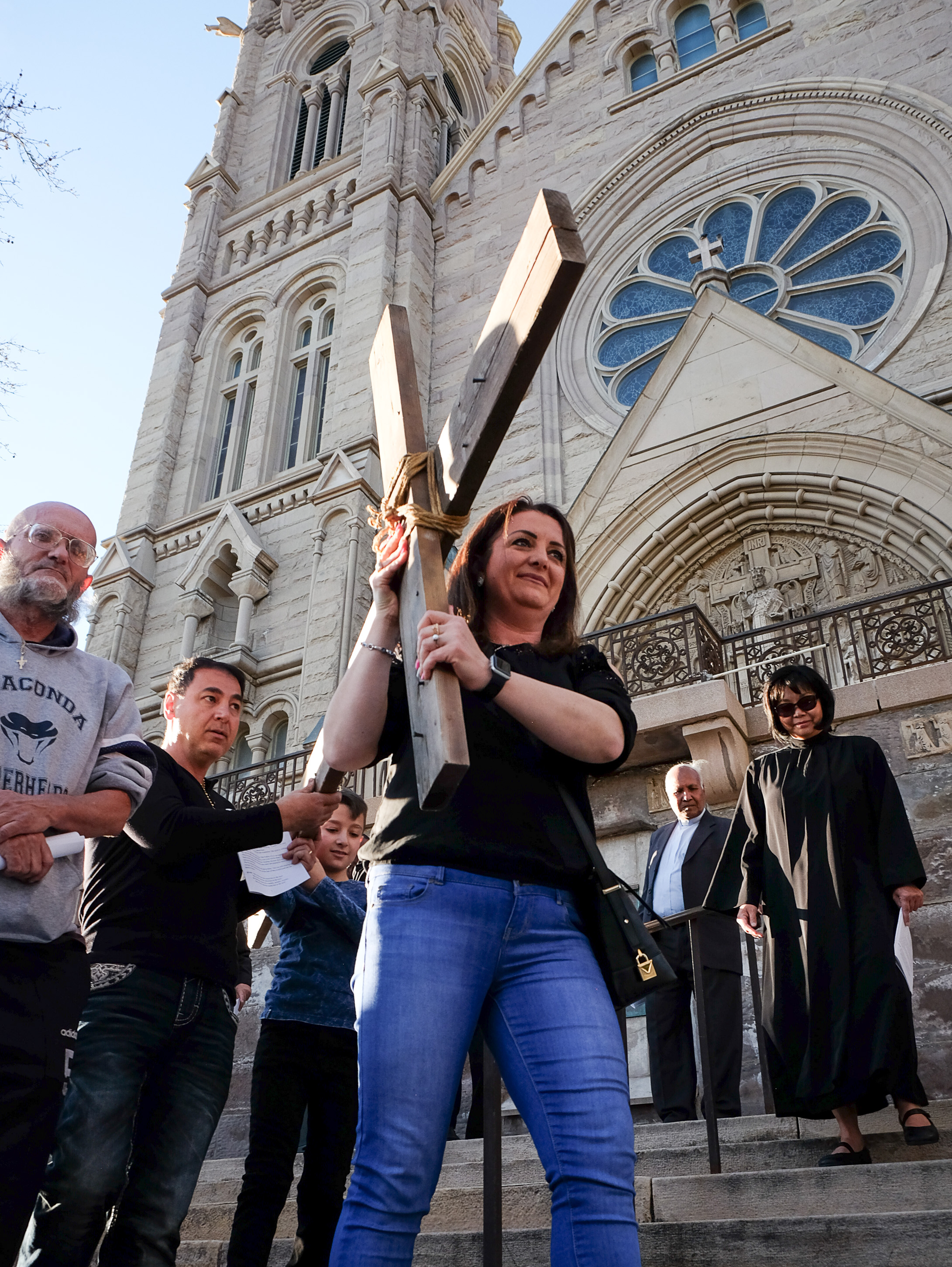 (Francisco Kjolseth | The Salt Lake Tribune) Nawal Zaflow takes the first turn as christians march through streets of Salt Lake City on Good Friday to symbolically mark Jesus' carrying the cross to his crucifixion beginning at Cathedral of the Madeleine.