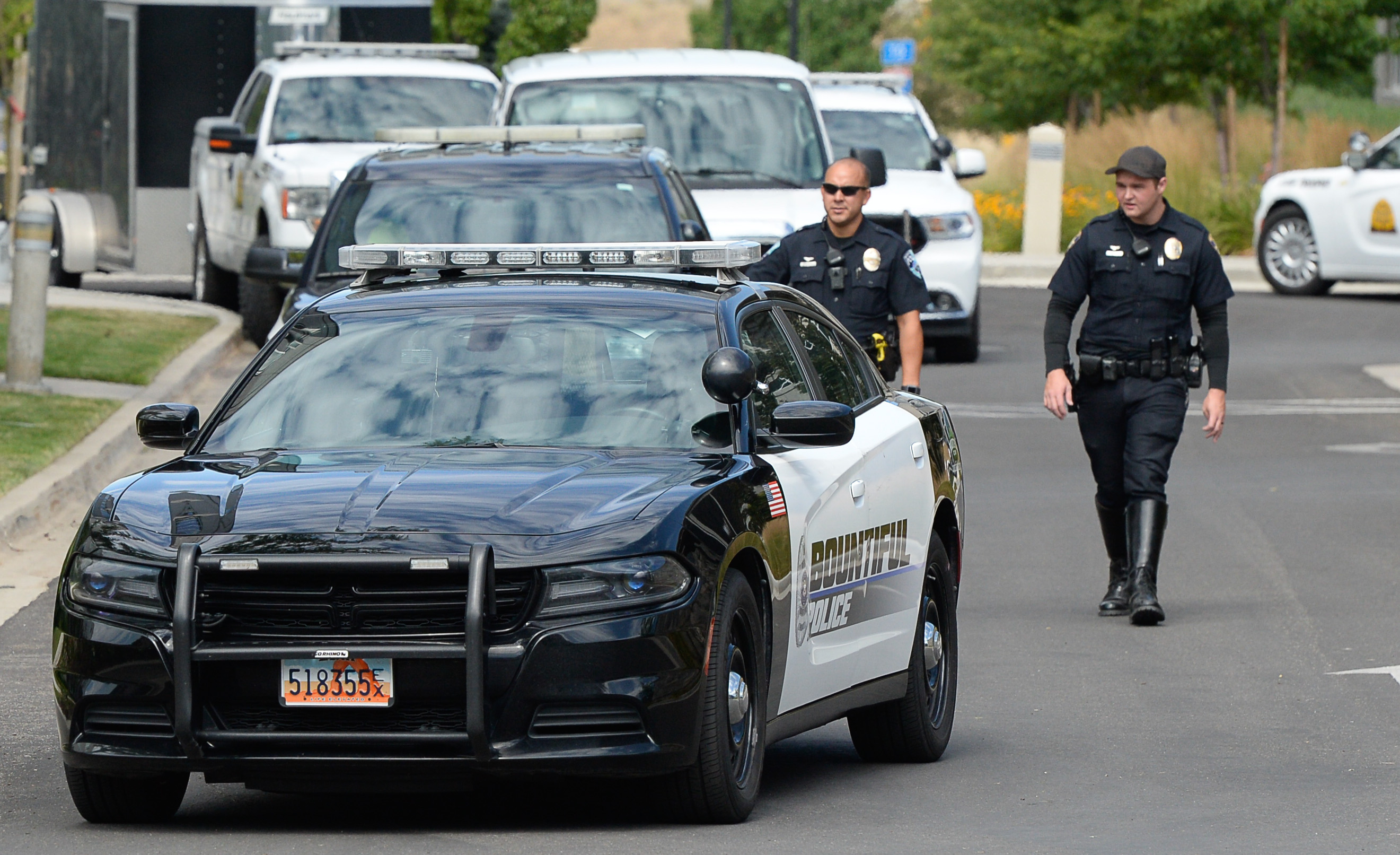 (Francisco Kjolseth | The Salt Lake Tribune) Police gather at the scene where activists staged a protest against a private prison company with contracts to hold undocumented immigrants on Thursday, July 12, 2018, at the headquarters of Management and Training Corporation in Centerville.