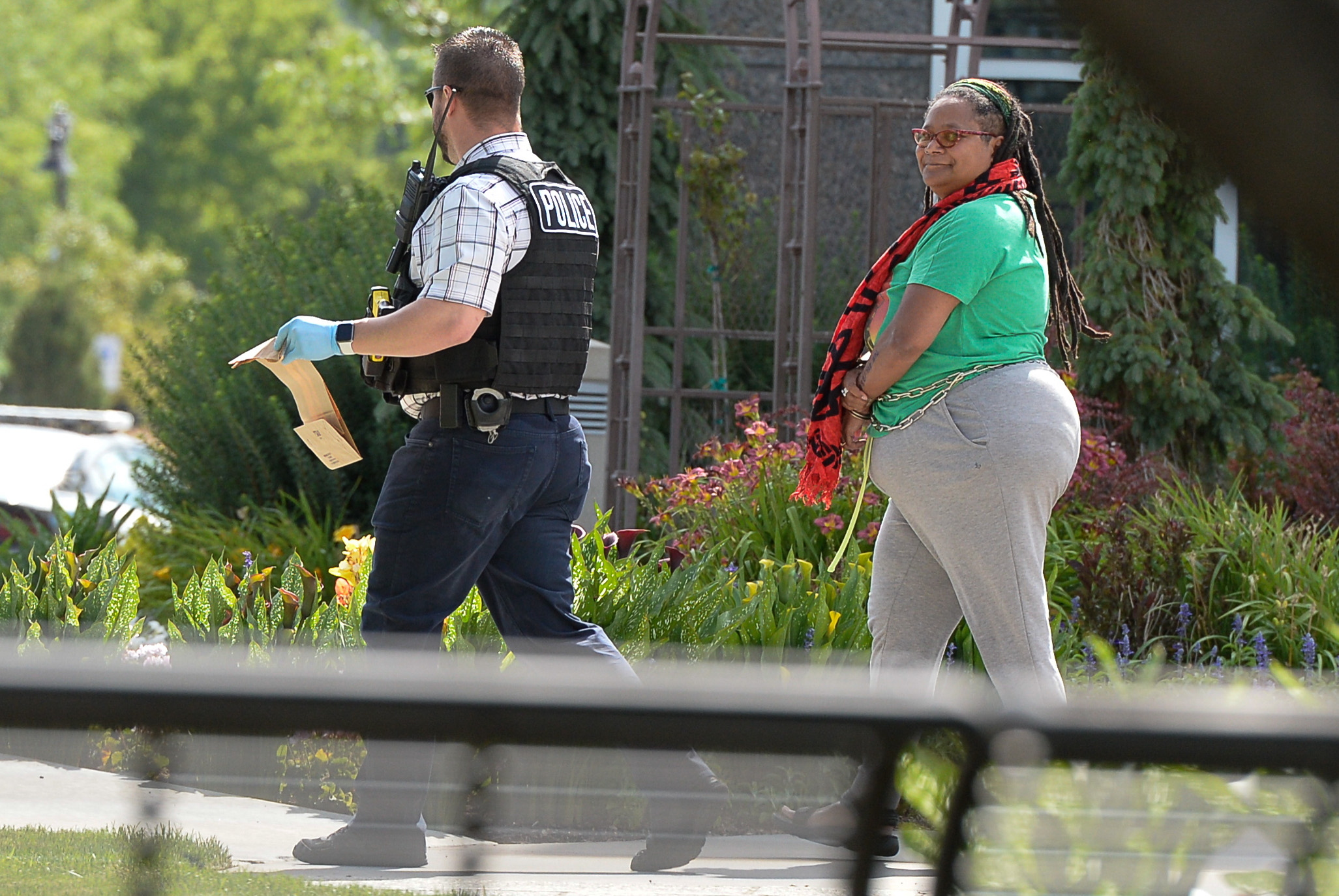 (Francisco Kjolseth | The Salt Lake Tribune) Activists are escorted out of a building where they staged a protest against a private prison company with contracts to hold undocumented immigrants on Thursday, July 12, 2018, at the headquarters of Management and Training Corporation in Centerville.