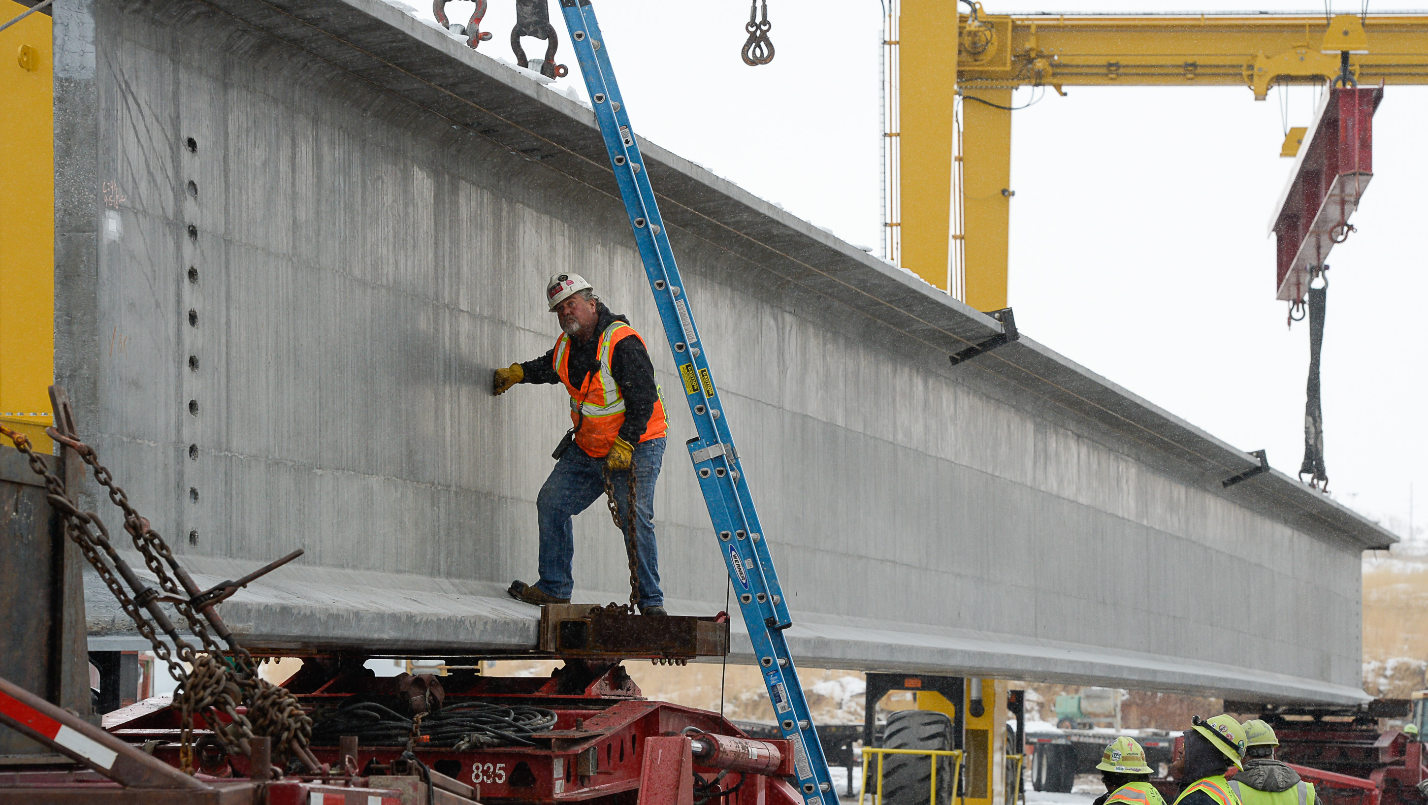 (Francisco Kjolseth | The Salt Lake Tribune) UDOT gets ready to place some of the world's largest-ever bridge beams, and the largest in Utah state history with a span of 203 ft long and just over 8 ft tall, as crews load one on a truck following manufacturing at Forterra Structural Precast in Kearns on Tuesday, Dec. 11, 2018. A total of six beams will be installed in the technology corridor in Lehi later this week.