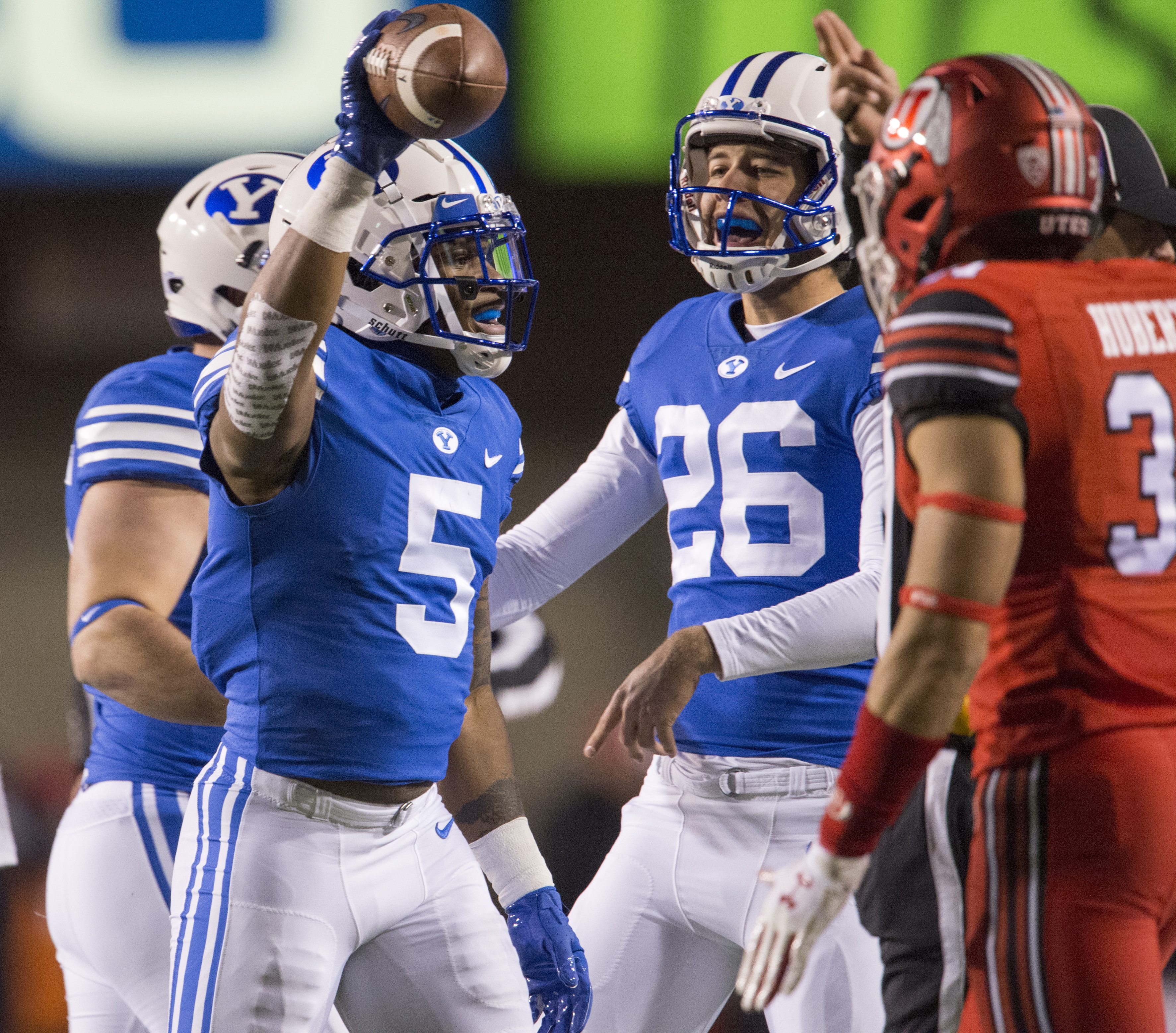 (Rick Egan | The Salt Lake Tribune) Brigham Young Cougars place kicker Rhett Almond (26) celebrates with Brigham Young Cougars defensive back Dayan Ghanwoloku (5) after he recovered a Utah fumble, in football action between the Brigham Young Cougars and the Utah Utes, at Rice-Eccles Stadium, Saturday, November 24, 2018. 