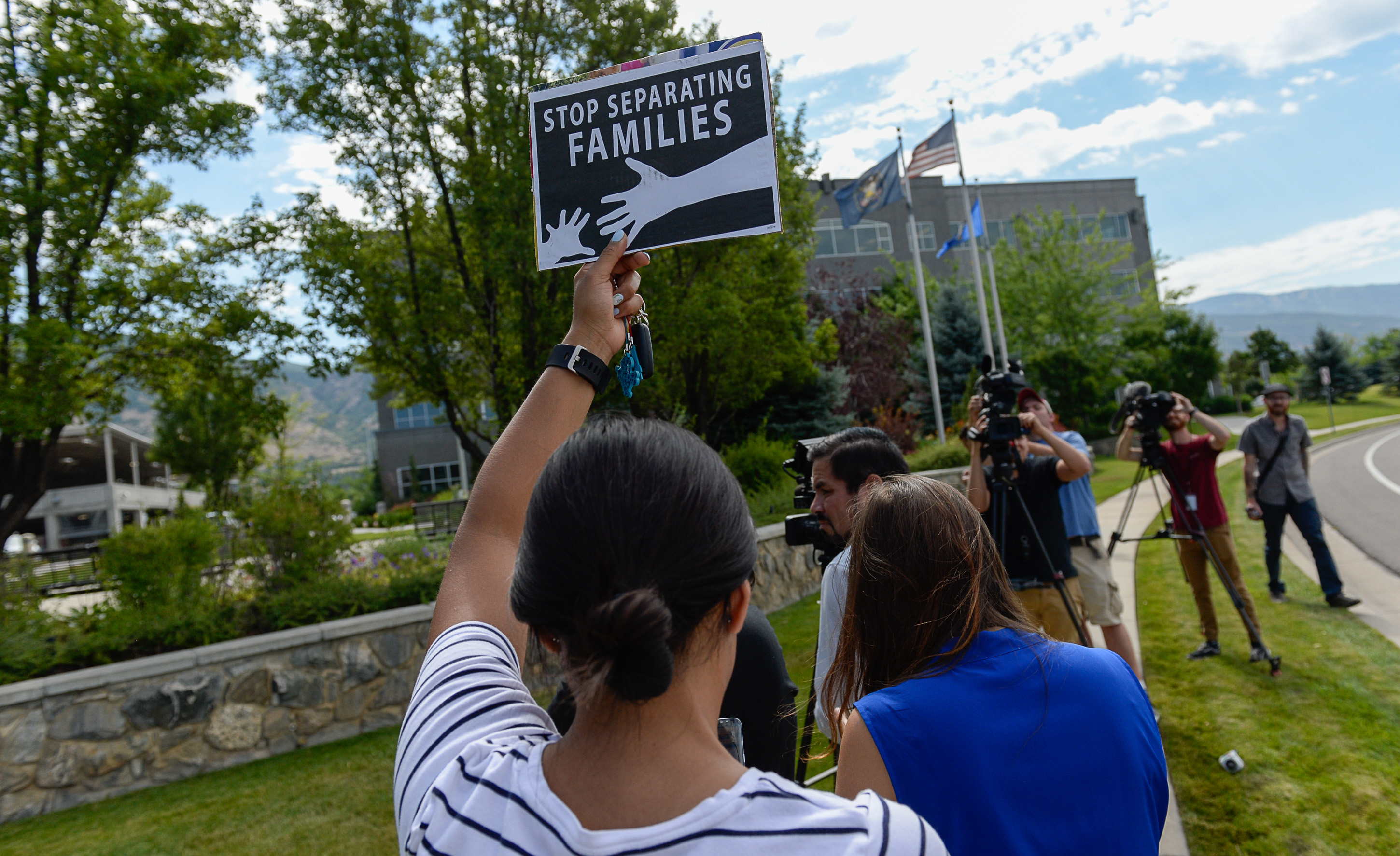 (Francisco Kjolseth | The Salt Lake Tribune) Activists stage a protest against a private prison company with contracts to hold undocumented immigrants on Thursday, July 12, 2018, at the headquarters of Management and Training Corporation in Centerville.