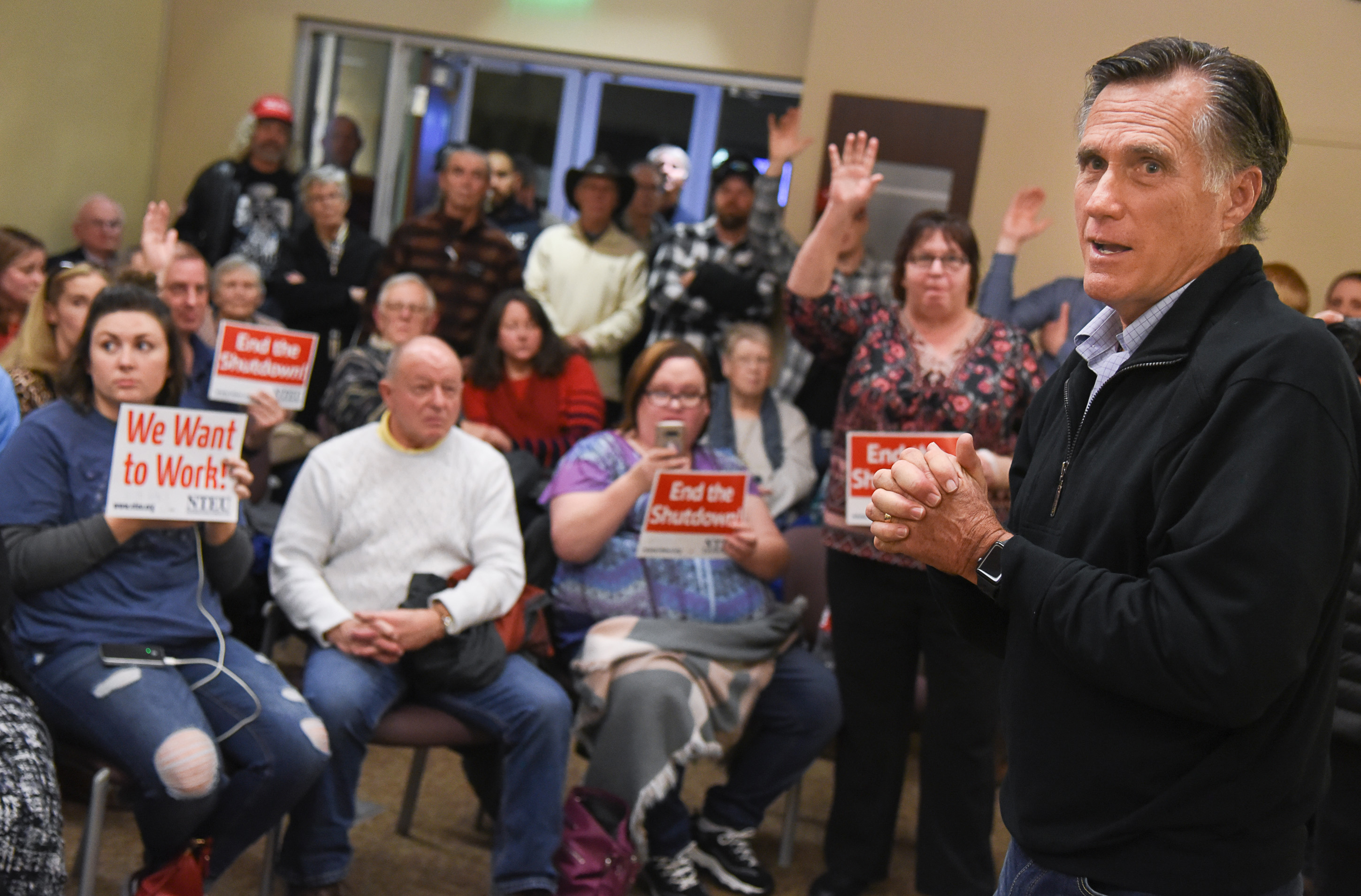 (Francisco Kjolseth | The Salt Lake Tribune) U.S. Senator Mitt Romney visits some of the overflow rooms where people expressed their anger over the federal shutdown after holding a town hall meeting at the Davis County administration building, Tuesday, January 22, 2019, to hear from local residents.