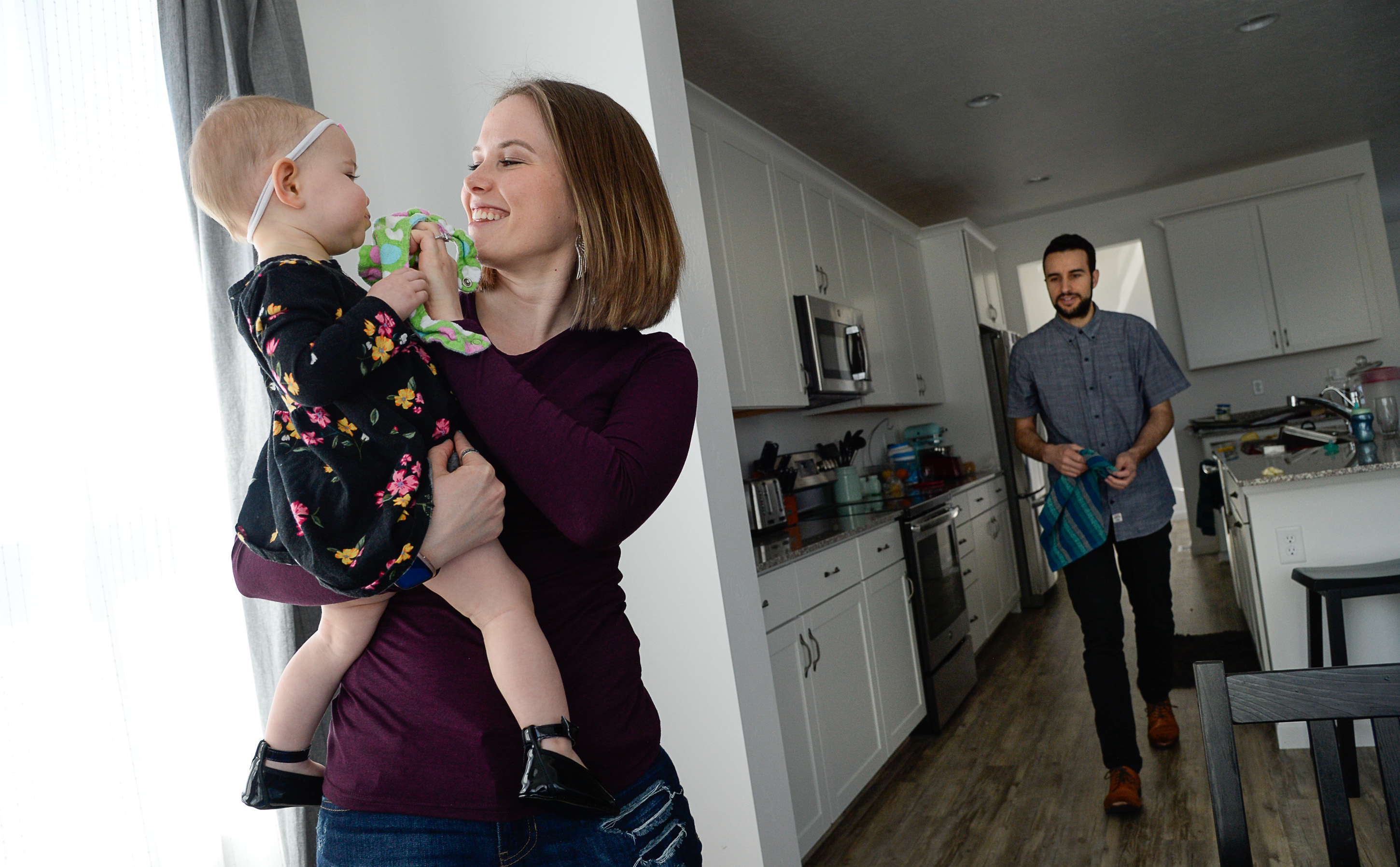 (Francisco Kjolseth | The Salt Lake Tribune) Ember and Jeremy Ulrich spend time with their daughter Jemma, 1, at their home in Lehi after moving from Pleasant Grove last October because they could get more house for their money there, and it's closer to Jeremy's job at Adobe in Lehi.