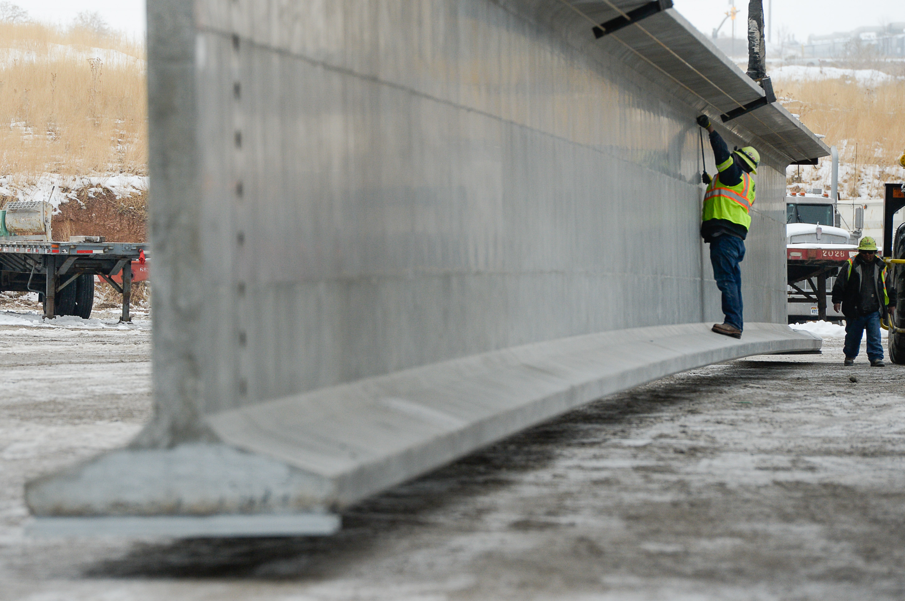 (Francisco Kjolseth | The Salt Lake Tribune) UDOT gets ready to place some of the world's largest-ever bridge beams, and the largest in Utah state history with a span of 203 ft long and just over 8 ft tall, as crews load one on a truck following manufacturing at Forterra Structural Precast in Kearns on Tuesday, Dec. 11, 2018. A total of six beams will be installed in the technology corridor in Lehi later this week.