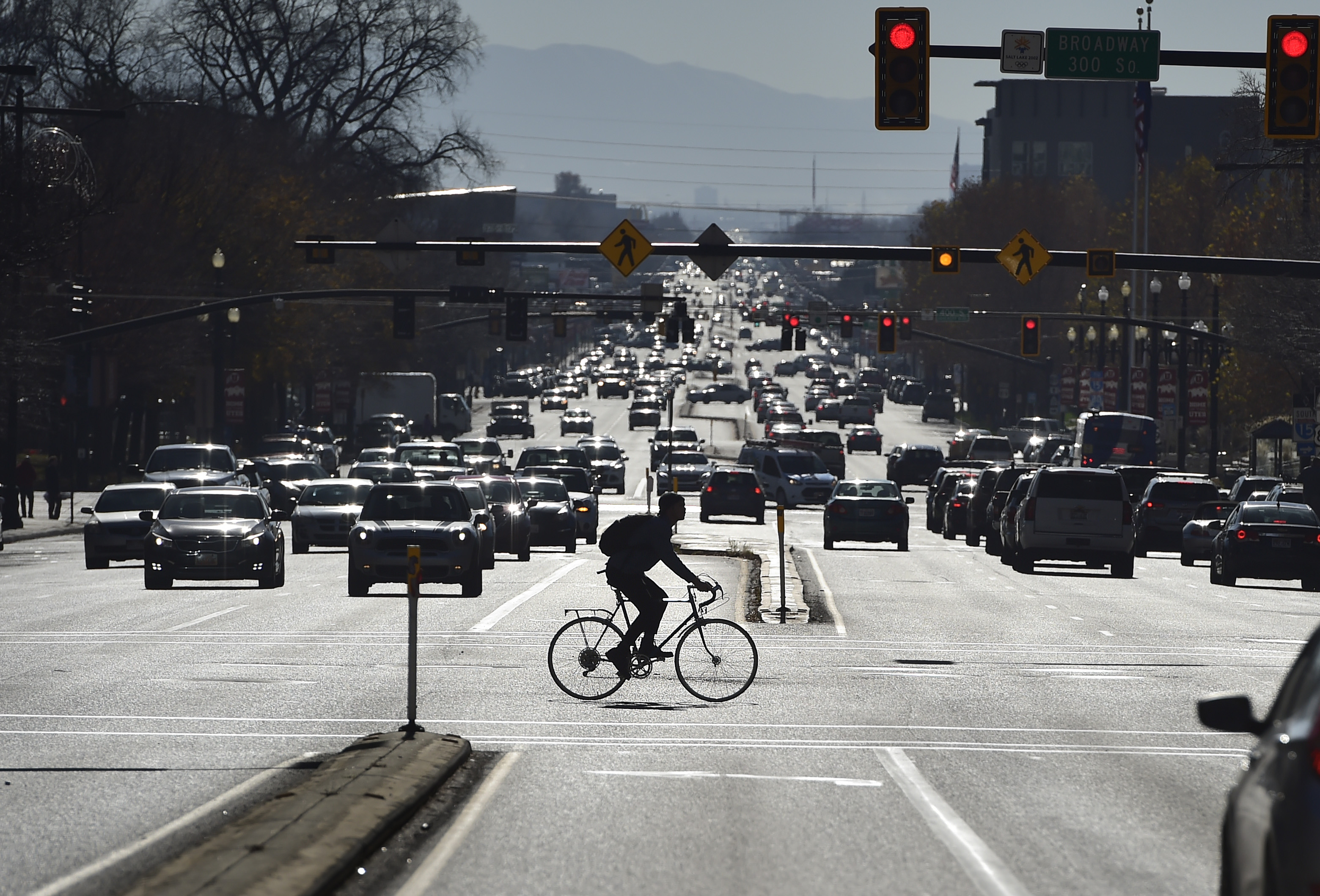 (Scott Sommerdorf | The Salt Lake Tribune)
A bicyclist braves downtown traffic on 300 South, while crossing State Street, Wednesday, Nov. 22, 2017.